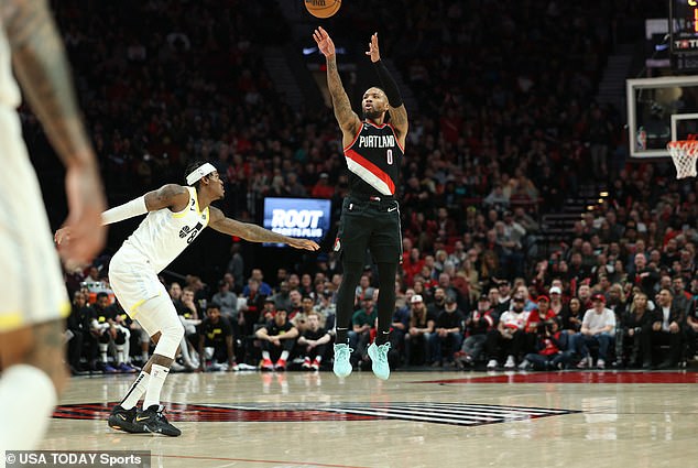 Trail Blazers guard Damian Lillard (0) fires a three-point shot over Utah's Jarred Vanderbilt