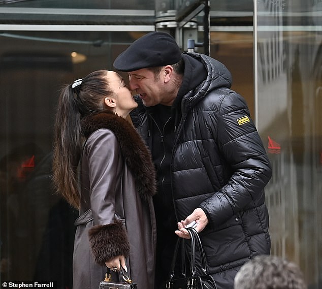 A cheeky kiss: David Seaman and his wife Frankie looked as loved up as ever when they shared a cheeky kiss outside the Lowry Hotel in Manchester