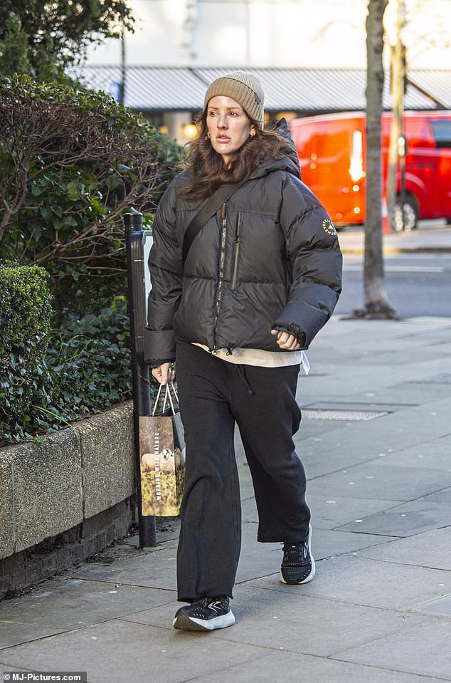 Staying warm: Ellie Goulding bundled up for the cold weather in a puffer jacket and beanie on Monday while running errands in west London