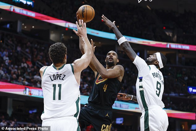 Cavaliers Evan Mobley shoots at Bucks center Brook Lopez and forward Bobby Portis