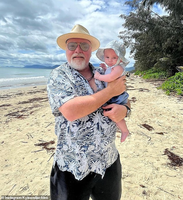 The jury is out on whether Kyle Sandilands' son Otto has inherited his looks from his famous dad.  (They appear together in Port Douglas, Queensland, during the Christmas holidays)