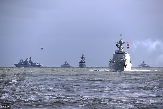 Chinese and Russian warships are pictured taking part in joint naval drills in the East China Sea in December