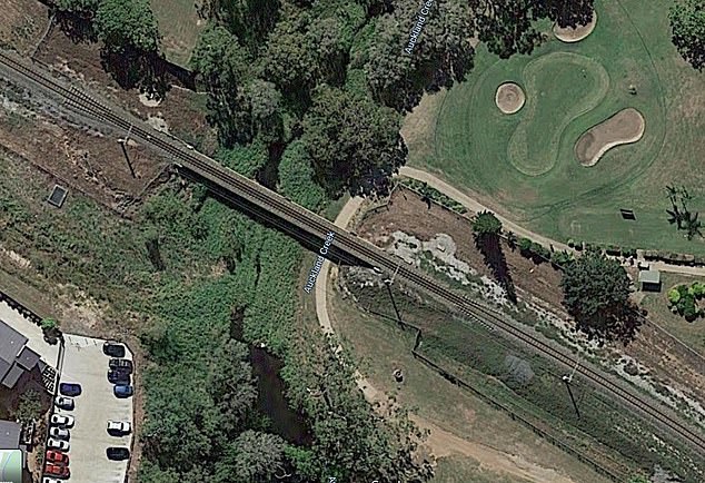 The train bridge spans Auckland Creek in Gladstone, Queensland