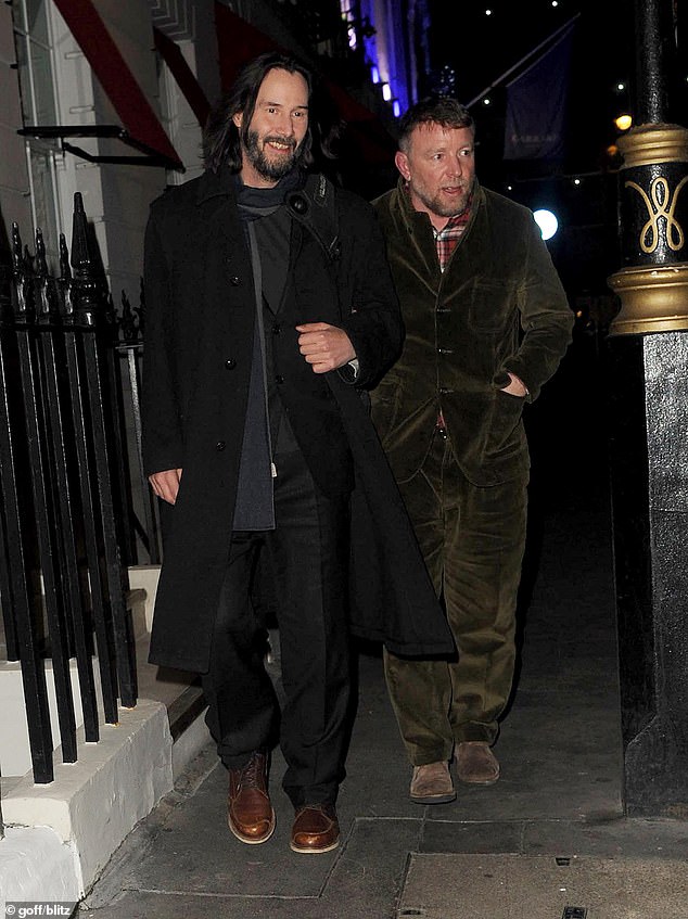 Side by Side: Keanu Reeves joined Guy Ritchie on Monday night as he returned home from a night out at a popular London nightspot.