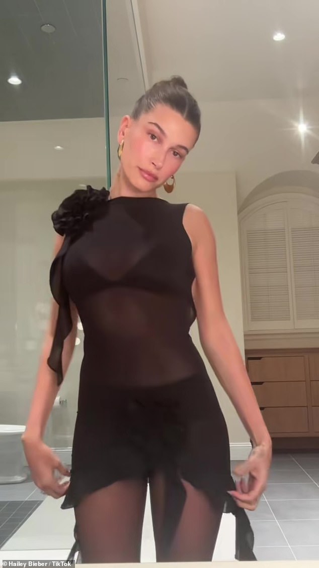 Wow!  Hailey Bieber cemented her status as a fashion icon in a see-through black minidress with a sultry open back, which she wore in her last two TikTok videos.