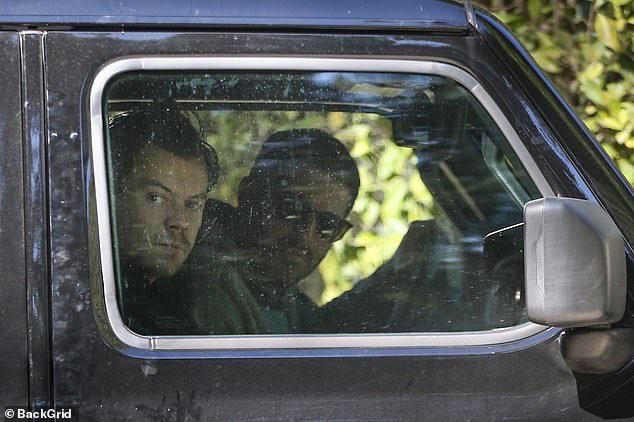 Out and about: Harry Styles was still working out when he left the gym with a friend in Santa Monia on Thursday.