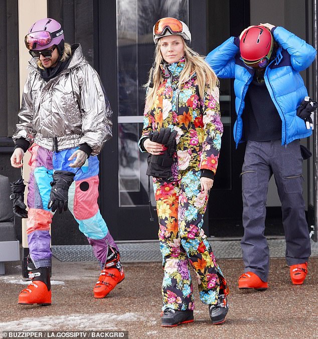 Flower power: Heidi Klum, 49, brought a burst of spring to the White Mountains of Aspen, Colorado on Wednesday when she hit the slopes in a floral ski outfit.  The supermodel has been enjoying a luxurious winter getaway with her husband Tom Kaulitz (33, right) and her twin brother Bill hers (left)