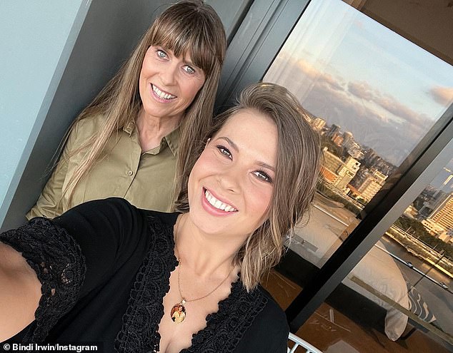 Fans wept after spotting a hidden detail in a photo Bindi Irwin (right) posted to Instagram on Saturday.  The 24-year-old conservationist posed for a selfie with her mother Terri (left) to celebrate her 'half-birthday of hers', which is a tradition observed by the Irwin family.