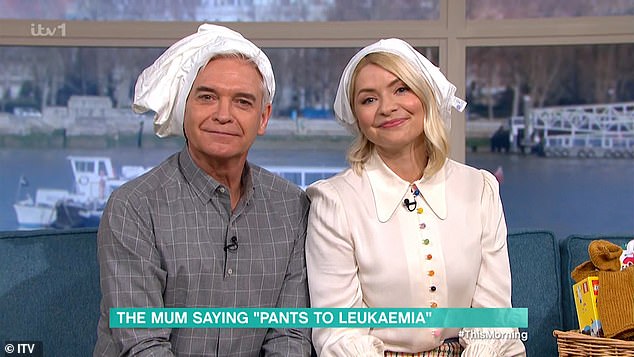 Charity: Holly Willoughby and Phillip Schofield wore pants over their heads as she supported her friend by talking about her son's battle with cancer on Friday's This Morning