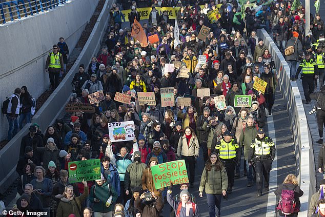 Hundreds of Extinction Rebellion protesters waved banners outside The Hague declaring 