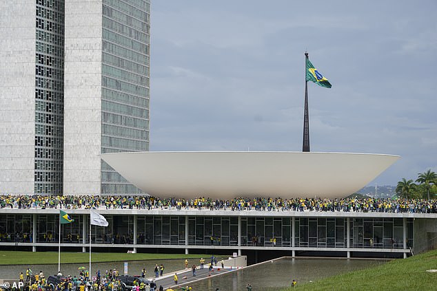 Bolsonaro supporters can be seen breaking through the barriers and entering the building on Sunday.