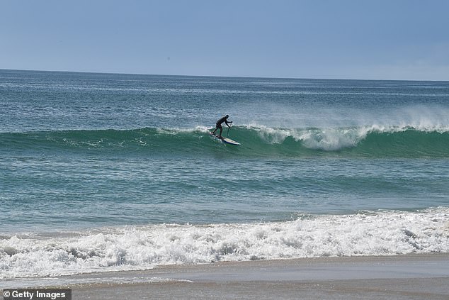 The 45-year-old father rushed into the waves at Lennox Head (pictured) on the northern coast of New South Wales after his daughter was swept out to sea on a body board