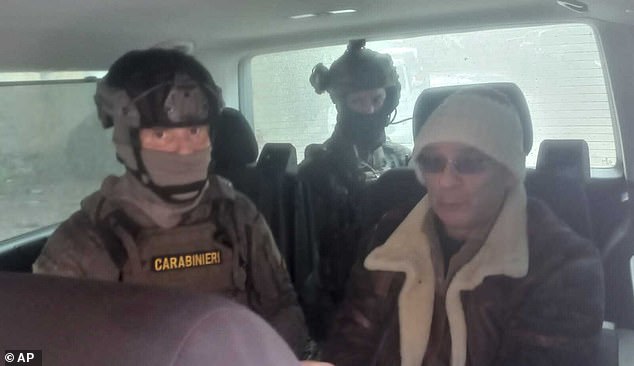 Matteo Denaro, right, is seen in a car with Italian Carabinieri officers soon after his arrest at a private clinic in Palermo, Sicily, after 30 years on the run