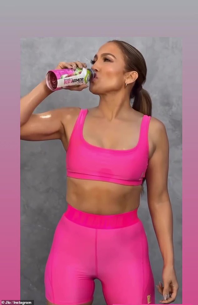 Having a drink: Jennifer Lopez showed off her toned physique in a promotional video that she shared on Instagram on Monday afternoon