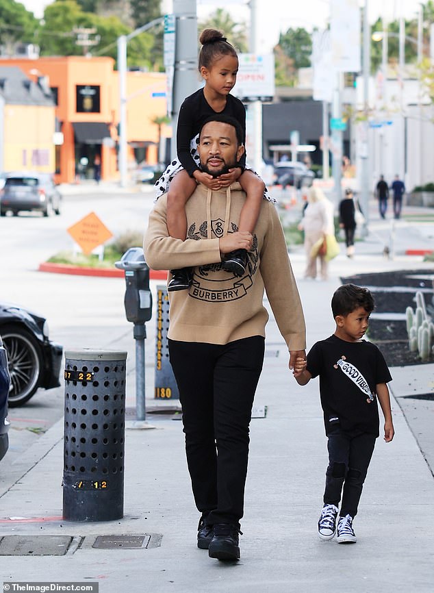 Practical: John Legend proved he's a dedicated father Saturday when he took daughter Luna and son Miles to a Los Angeles park.