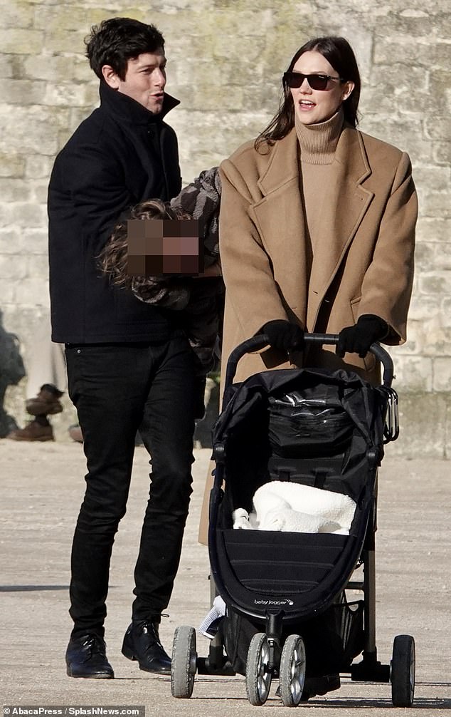 Karlie Kloss wears a chic neutral winter look as she strolls through Paris with her husband Joshua Kushner and their 22-month-old son Levi during the city's Fashion Week.