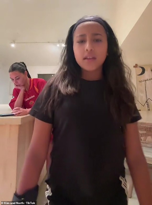 Cool and cool: Kim Kardashian seemed unbothered by ex Kanye West's latest headline incident when she appeared in a new TikTok clip with her daughter North West on Friday night