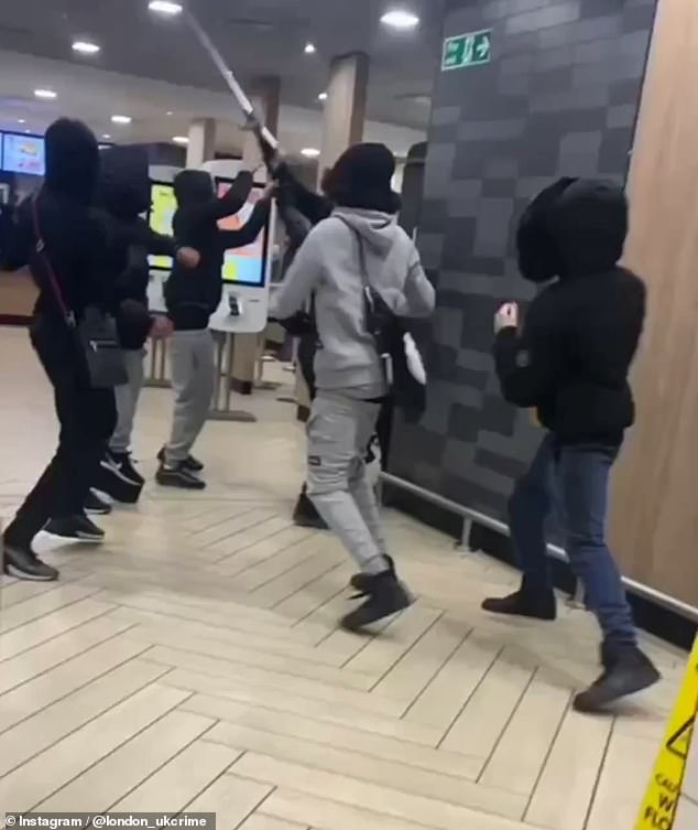 The fight broke out yesterday at a McDonald's in Hackney, London, in front of several horrified customers.