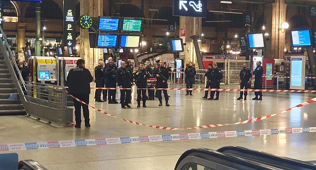 A man with a knife has attacked and injured several passengers at the Gare du Nord station in Paris.  Pictured: Police on the scene