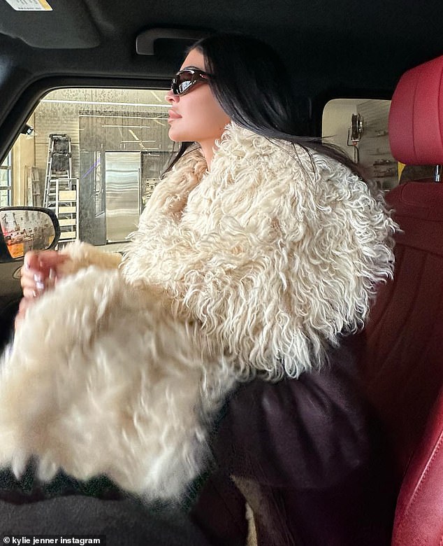 Kick off 2023 in style: Kylie Jenner sat in the front seat of a luxurious Mercedes G-wagon SUV wearing an oversized coat with white fur as she ringed in the new year with her sister Kendall and a few friends on a glamorous snow trip in Aspen, Colorado