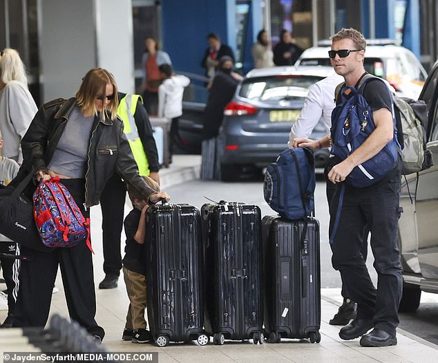 Sam and Lara Worthington looked nervous on Friday as they argued with their three young children during check-in at Sydney airport.