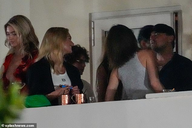 Partying: Leonardo DiCaprio seemed to have his head turned by two 27-year-old women, as he spent the night flirting with models Rebecca Donaldson and Lilia Weddell