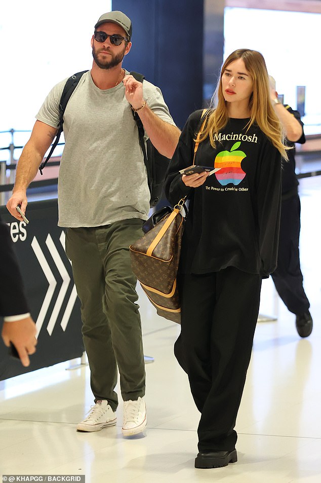 Liam looked to be every inch the coolest cucumber when he was photographed arriving at Sydney airport with his girlfriend, Gabriella Brooks, on Monday.  both in the photo