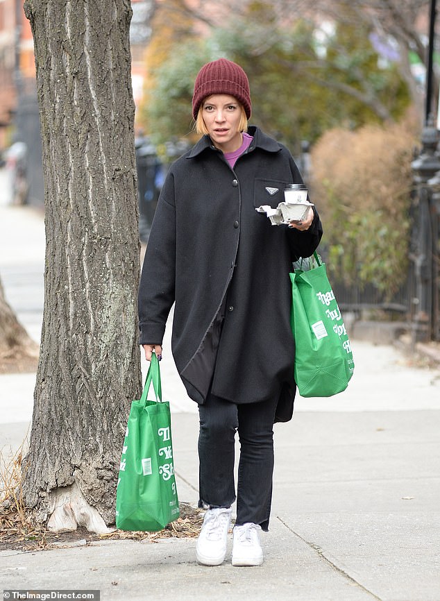 New look: Lily Allen showed off a glimpse of her freshly dyed strawberry blonde hair under her red beanie on Sunday as she headed out to a cafe in New York City