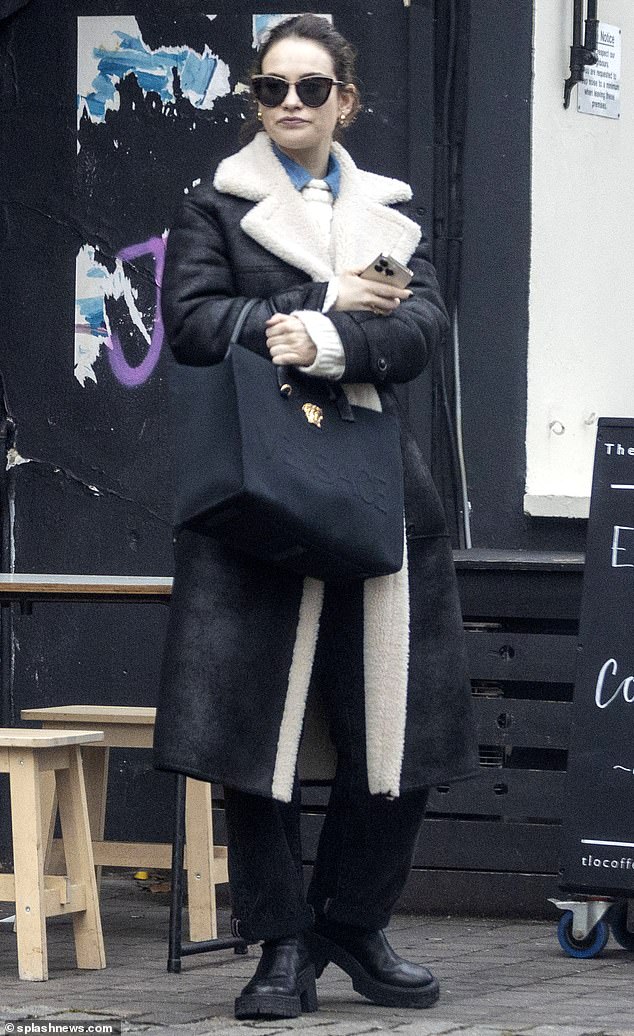 Chic: Lily James was spotted wearing a full-length shearling coat similar to the one worn by legendary football commentator John Motson