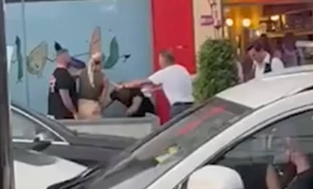 The fight took place around 8pm Tuesday night directly outside France-Soir with Andrew Fox (in white), helping to break it up.