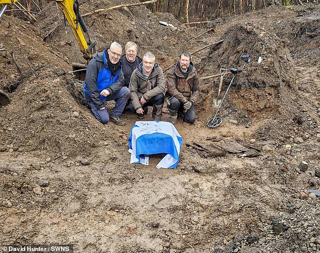 The lost grave of a film star dog who played Greyfriars Bobby in a 1960s Disney movie has been found after an 18-month search. The Skye terrier, also called Bobby, enjoyed a period of fame after the film was released in 1961. Pictured are the discoverers of the little coffin that was buried in 1974, draped in a Scottish flag (from left to right, Paul Aitken, George Gordon, David Hunter and Paul Macdonald)