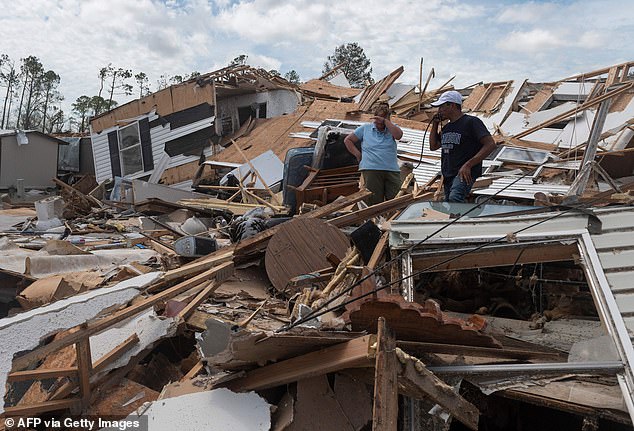 A couple checks out their destroyed mobile home after Hurricane Laura in Lake Charles, Louisiana, in August 2020