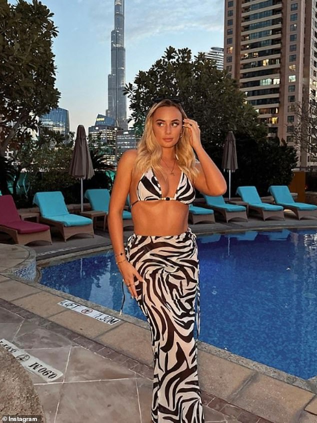 'Fresh Faced Beach Girls': Millie Court showed off her washboard abs in a daring black and white bikini on Tuesday as she enjoyed a relaxing day by the pool in Dubai with Chloe Burrows