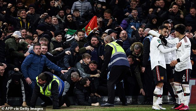 It looked like things could have turned ugly when United fans fell on the billboard.