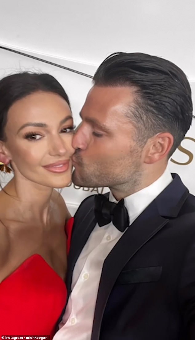 Sweet: Mark Wright planted a kiss on his wife Michelle Keegan's cheek as they shared a photo from their trip to Dubai on Wednesday