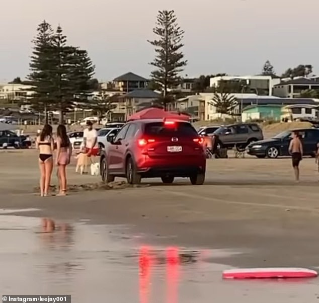 A woman has lost her license after driving erratically around families with young children on a busy Australian beach.