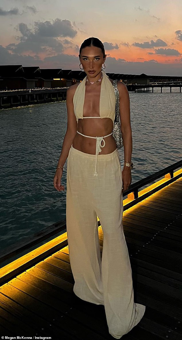 Sunkissed: Megan McKenna showed off her taut midriff on Friday night when she donned a low-rise linen pant with a matching string crop top during her £1.2K-a-night Maldives getaway