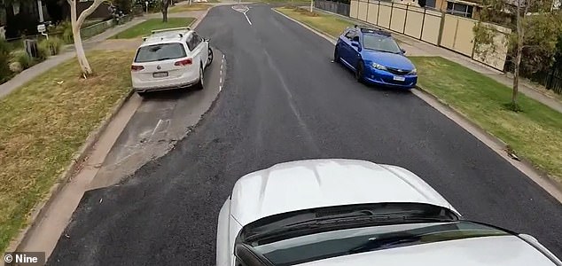 Locals were outraged after lazy council workers repaved a suburban street around parked cars leaving huge gaps in the road (pictured)