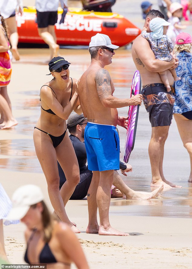 On January 7th, Michael Clarke and Jade Yarbrough went to the beach and seemed happy and relaxed as they exchanged pleasantries and made fun of each other at the water's edge.