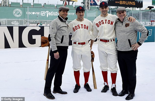 General manager Don Sweeney, Brad Marchand #63, Patrice Bergeron #37 and head coach Jim Montgomery of the Boston Bruins pose for a photo before the game against the Pittsburgh Penguins in the Discover NHL Winter Classic 2023 at Fenway Park on Monday