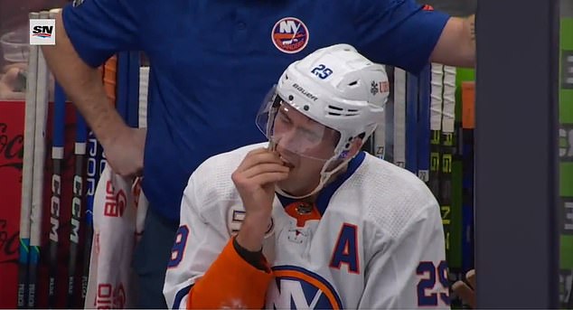 Brock Nelson was seen pulling a tooth out of his mouth while sitting on the Islanders' bench.