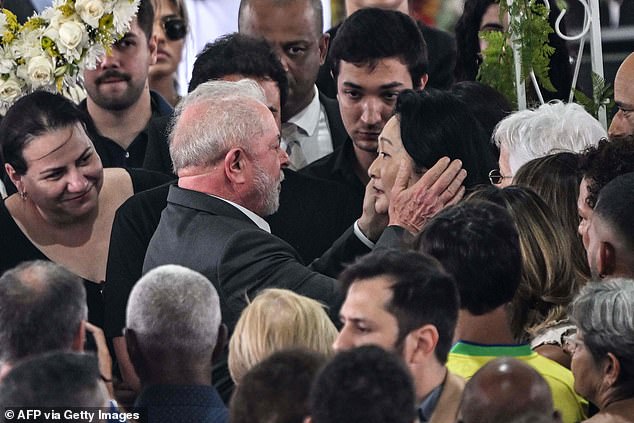 Pictured: Brazil's new president, Luiz Inácio Lula da Silva, comforts Pelé's widow at the wake for soccer stars in Santos, Brazil, on Tuesday.