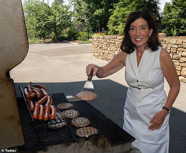 New York Gov. Kathy Hochul's proposal to ban gas stoves in new homes by 2025 is facing backlash from critics who accuse it of being hypocritical.  She is pictured using a gas grill.