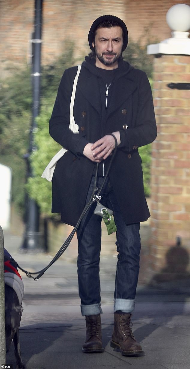 Out and about: Newly single Alex Zane, 43, was out for a walk alone with a dog after splitting with wife Nettie Wakefield on Saturday