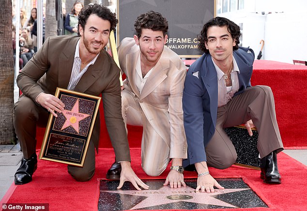 Congratulations!  The Jonas Brothers were inundated with applause and support as they received their star on the Hollywood Walk of Fame as their wives and respective children looked on.