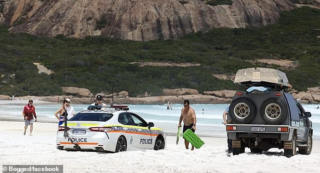 Police officers have been forced to ask tourists for help in getting their Toyota Camry out of trouble after getting stuck on a popular Western Australian beach.