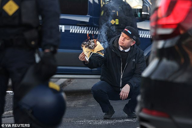 Far-right politician Rasmus Paludan burns a copy of Kuran in front of the Turkish embassy in Copenhagen today