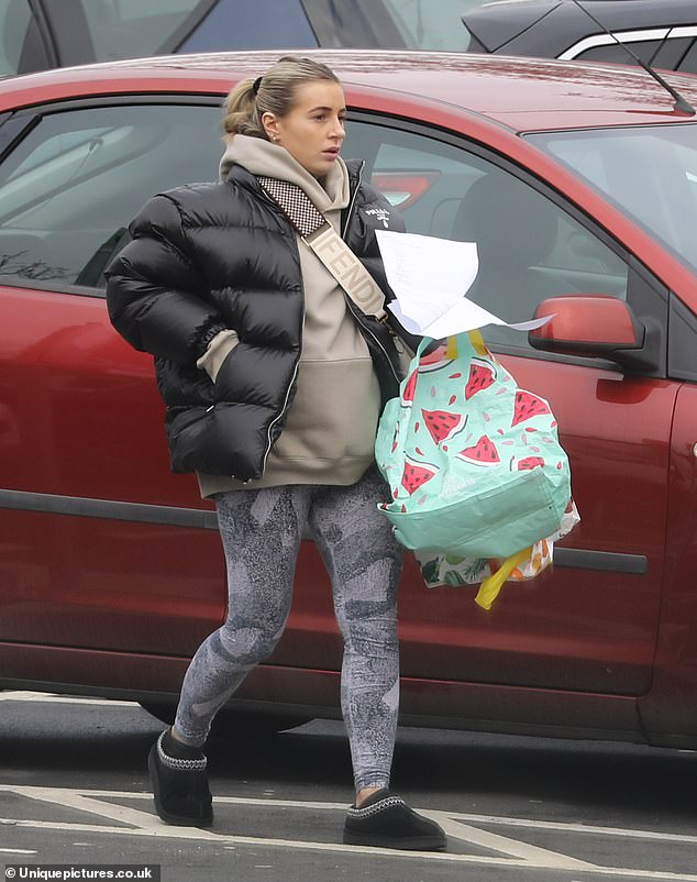 Out and about: Dani Dyer, who is expecting twins with boyfriend Jarrod Bowen, showed off a casual figure as she headed to her local supermarket on Sunday wearing £5k worth of designer clothes.