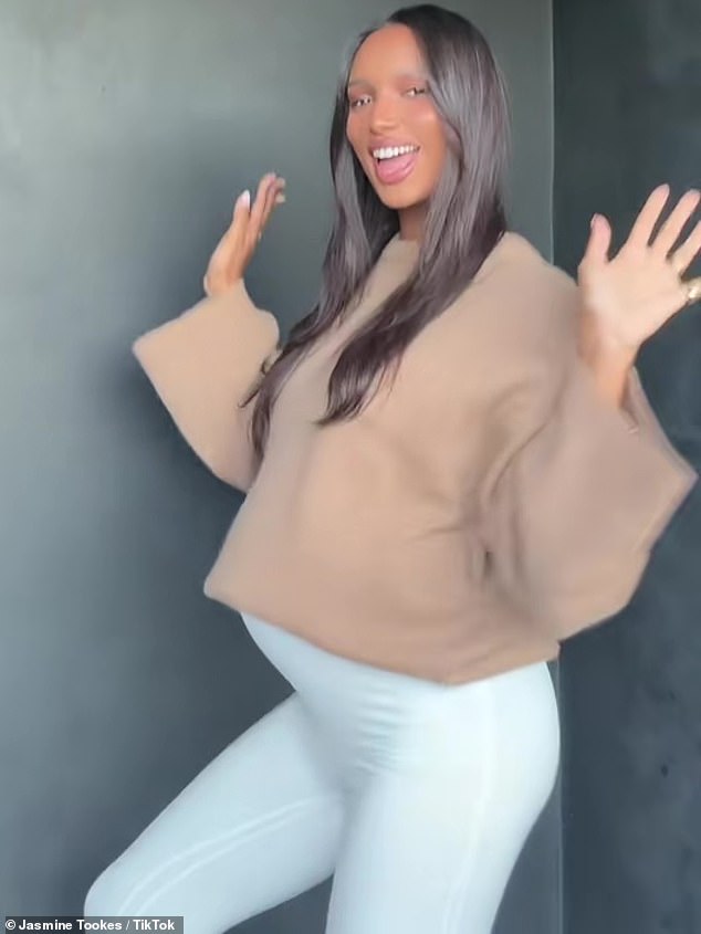 Looking fabulous: Jasmine Tookes covered her tummy in a camel-hued flowy maternity top in a lovely new TikTok this week