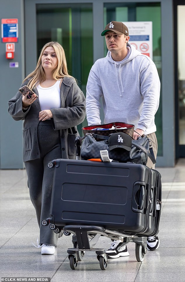 Back home: Shaughna Phillips, 28, was seen with her boyfriend Billy for the first time when the couple touched down at Heathrow on Thursday after their getaway to Los Angeles.